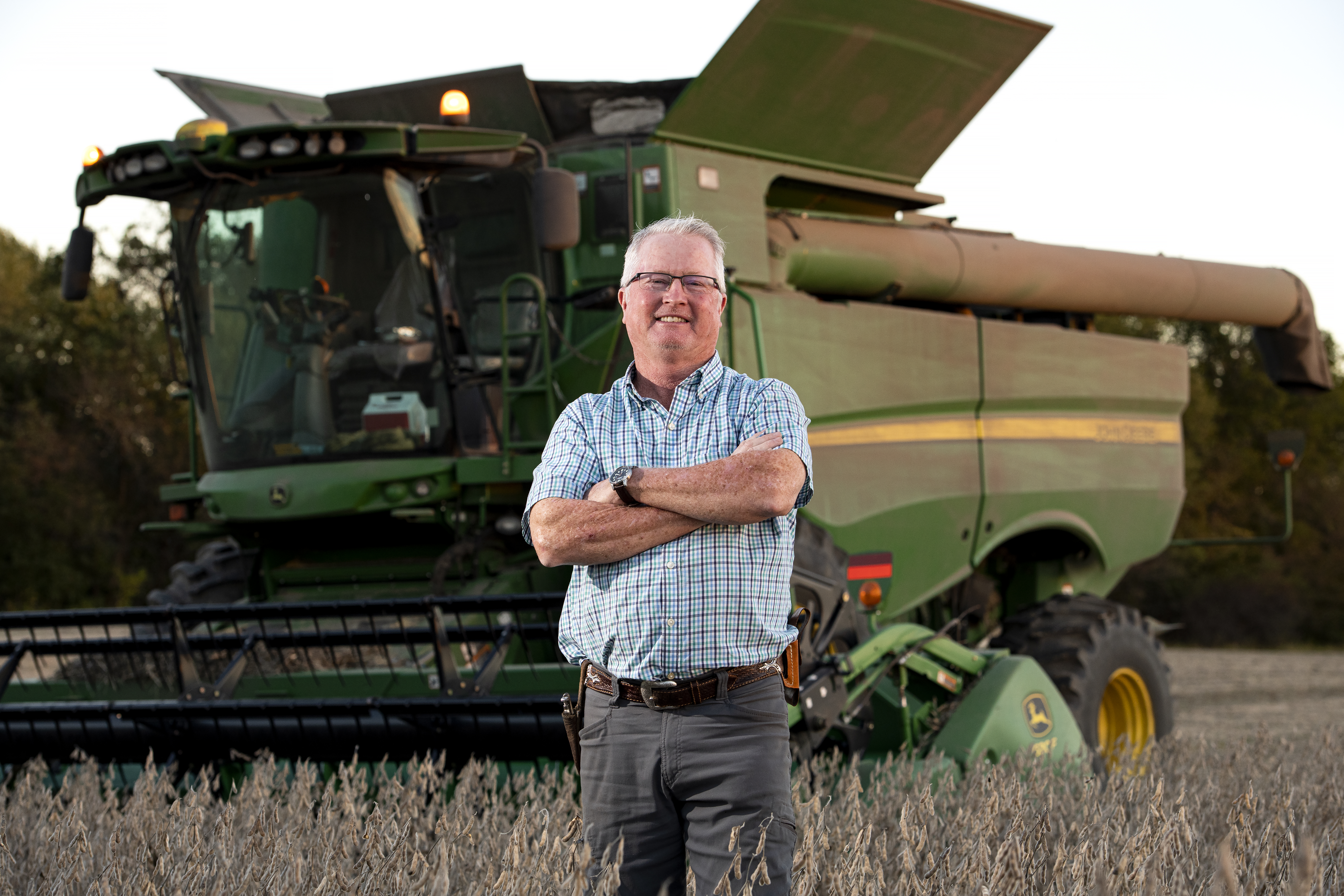 Ronnie Russell in front of a john deere machine
