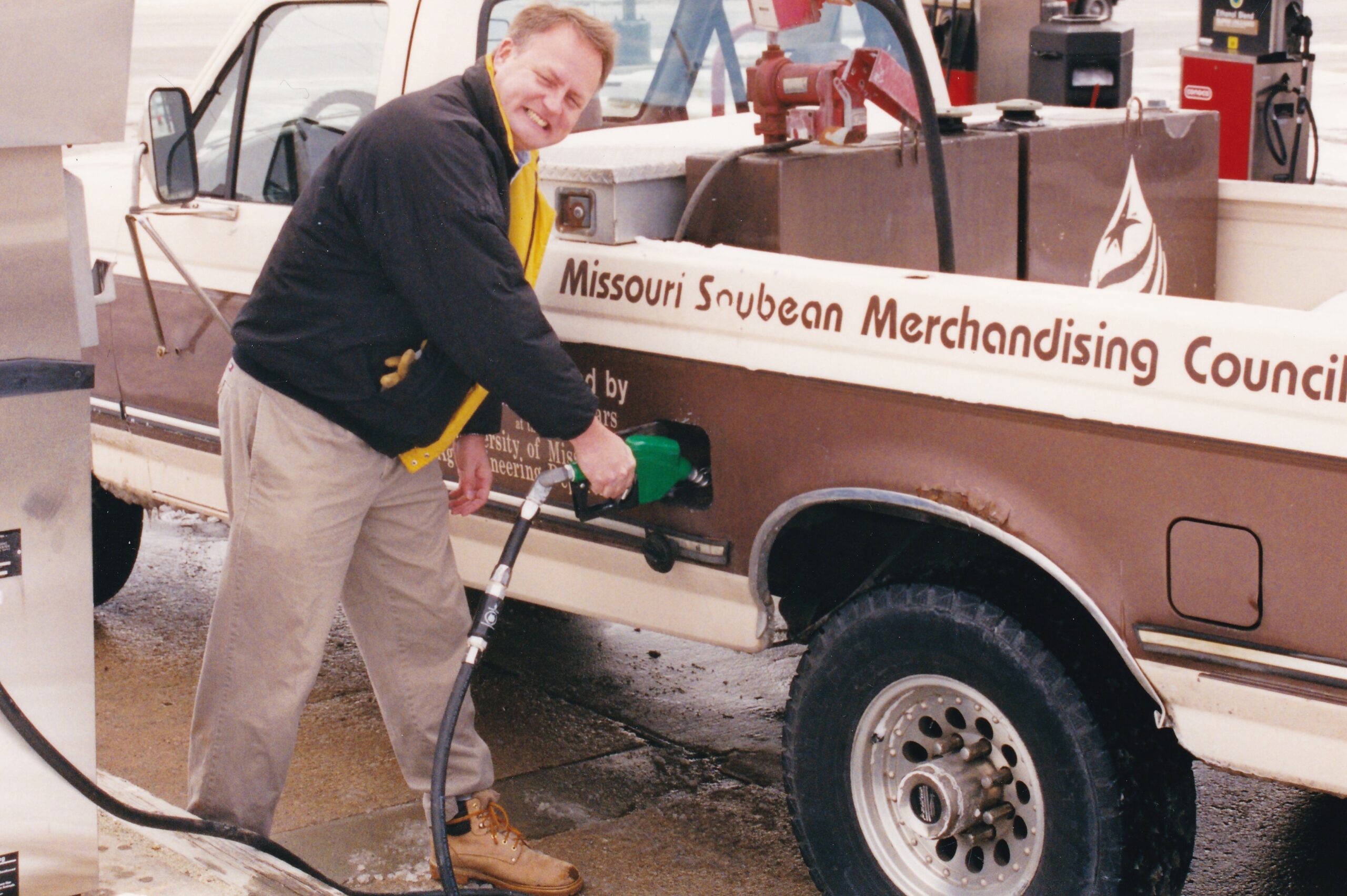 Man pumping gasoline into a MSMC truck