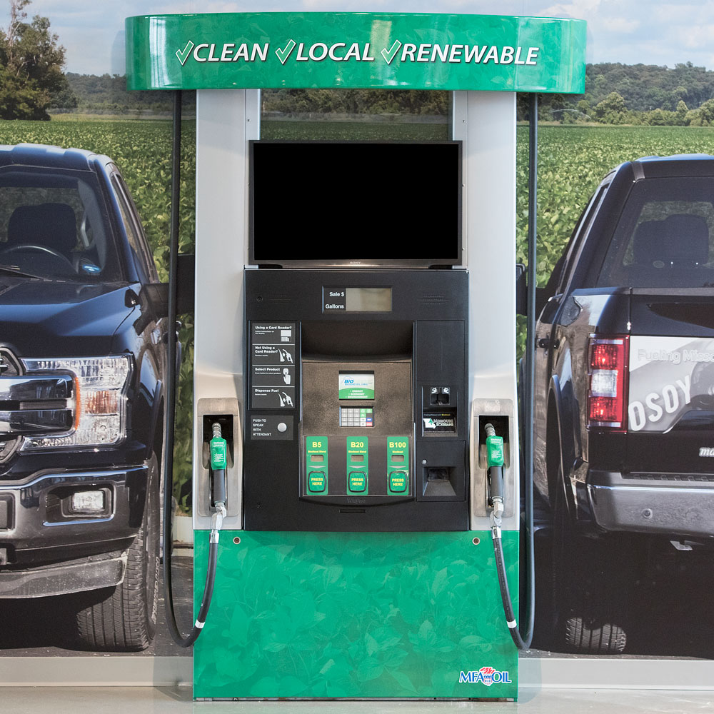 biodiesel fuel pump between two pickup trucks