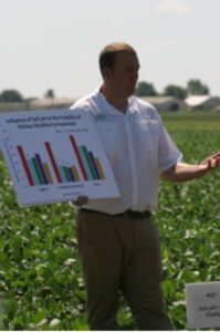 Eric Oseland presenting in a soybean field.