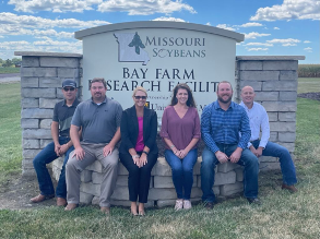 Seven Missouri Soybean Growers in front of Bay Farm Research Institute sign